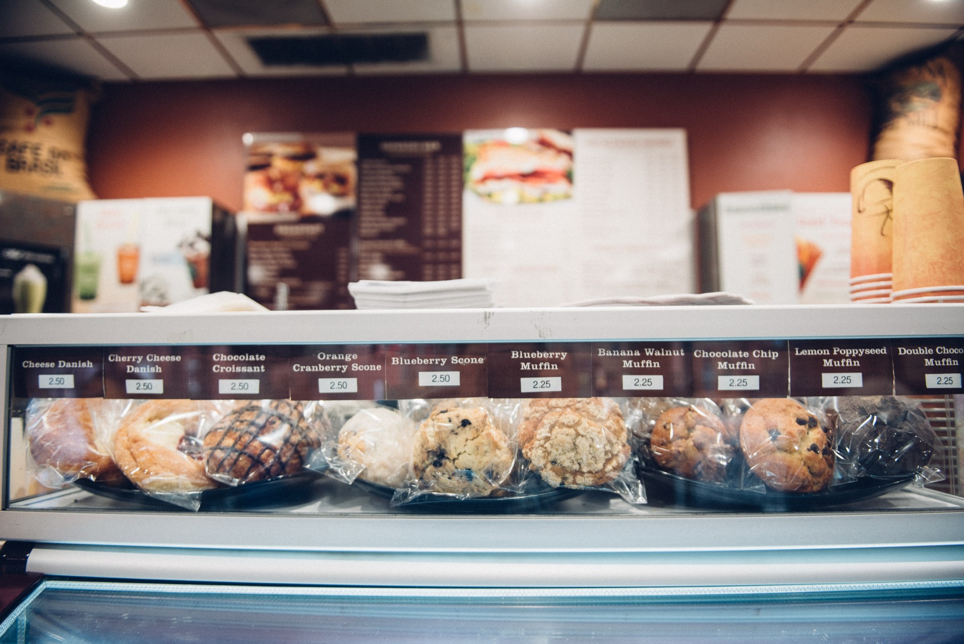 Display case of fresh muffins, scones and danishes